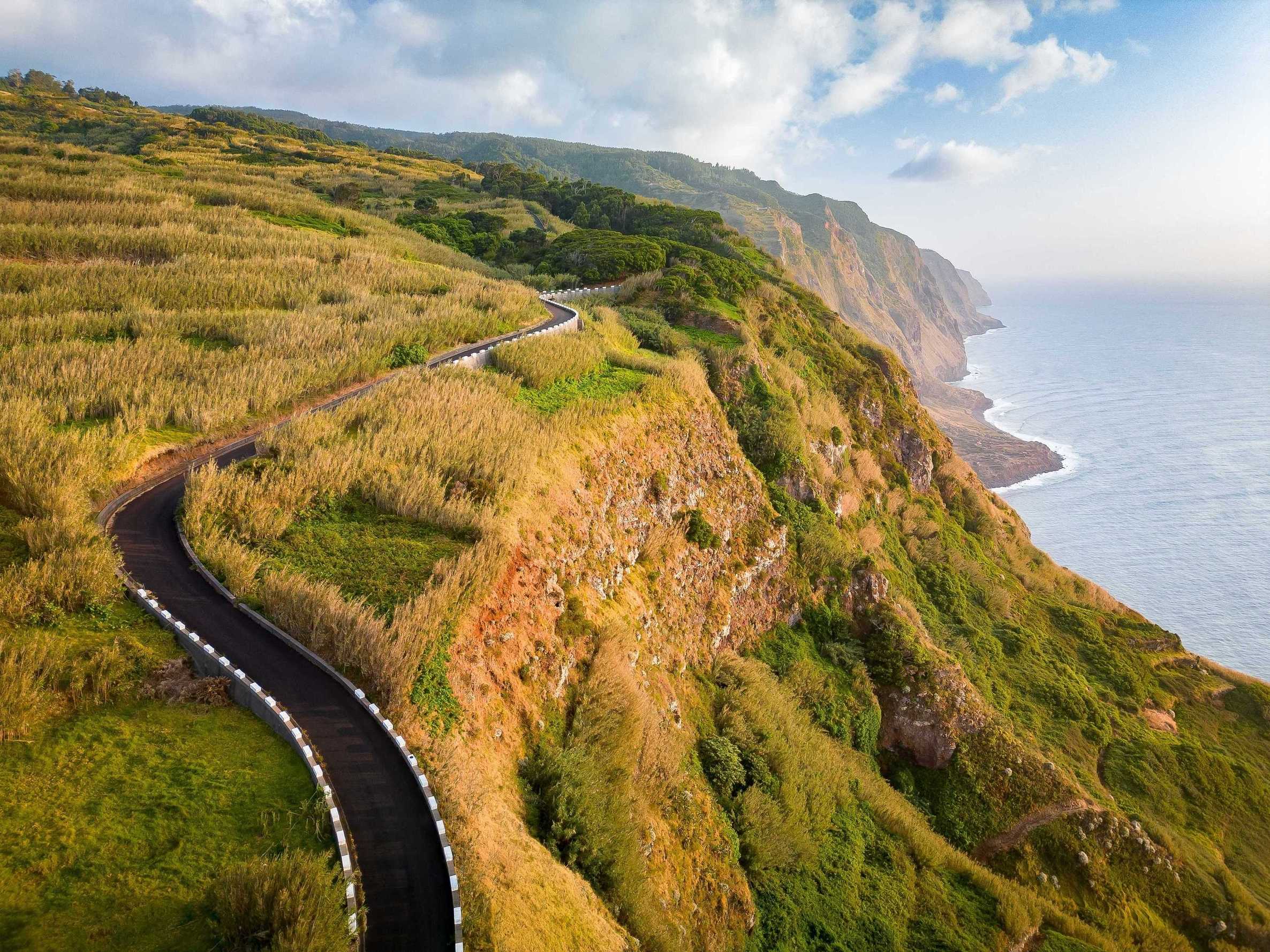 Aerial view of coastal path at sunset on Madeira Island, Portugal demonstrating importance of car hire excess insurance.