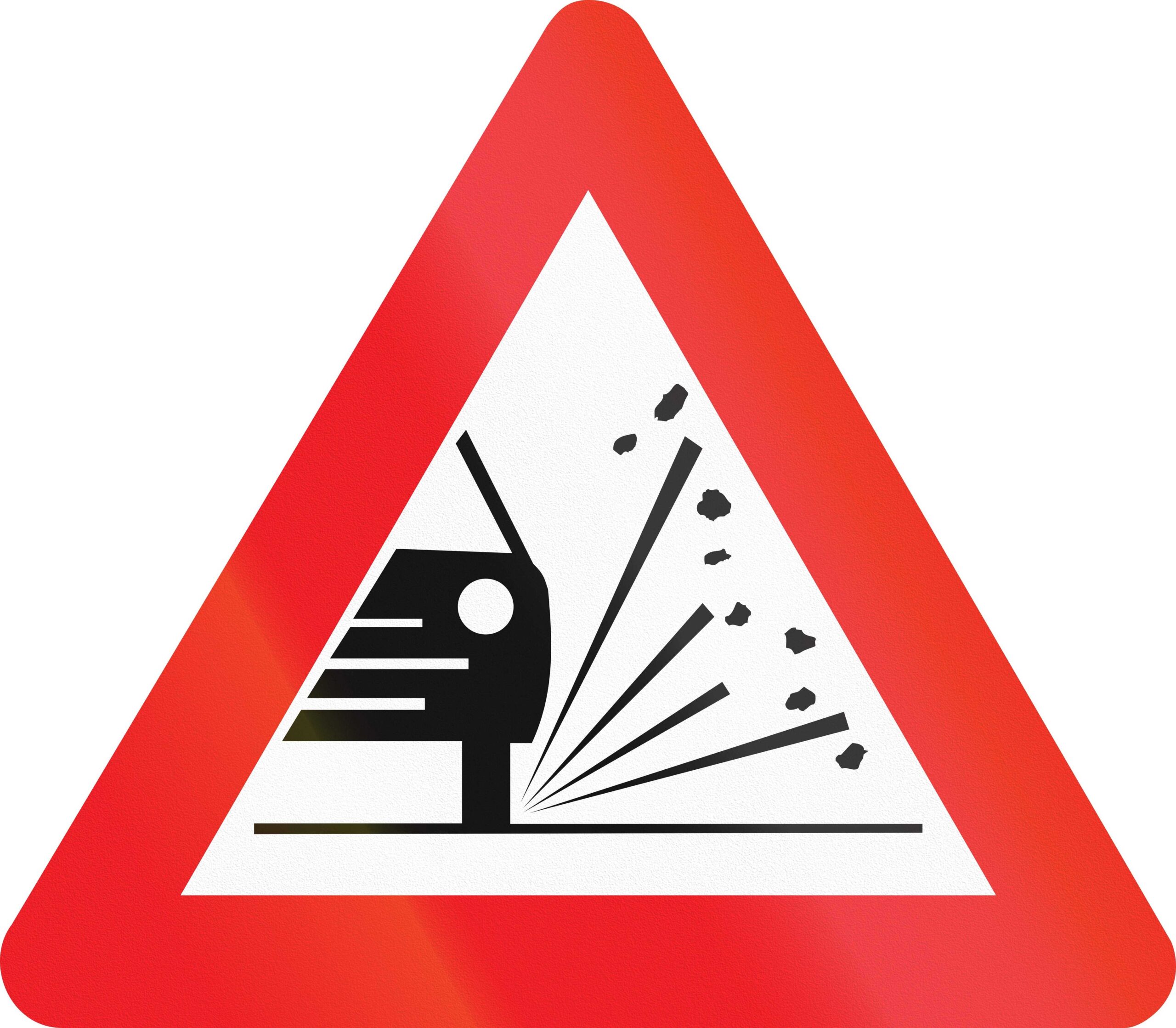 Portuguese road sign warning drivers there potentially may be loose chippings and stones.